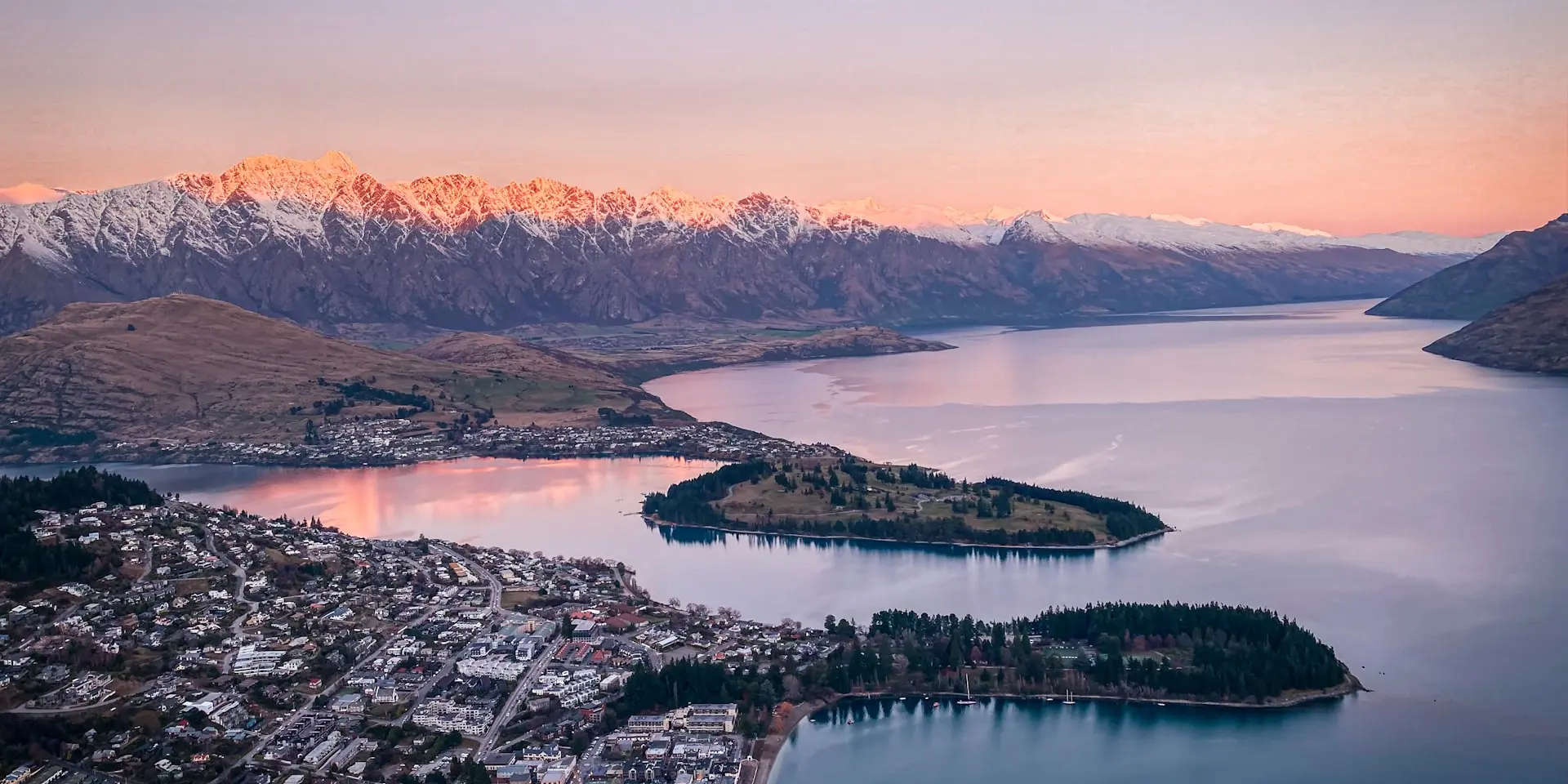 Queenstown waterfront with The Remarkables mountain range reflected in Lake Wakatipu